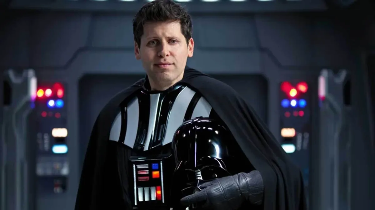 Mees, kellel on seljas Darth Vaderi kostüüm, seisab siseruumis, kus taustal on näha tehnoloogiaga seotud üksikasju. Mees hoiab ühes käes Darth Vaderi kiivrit.